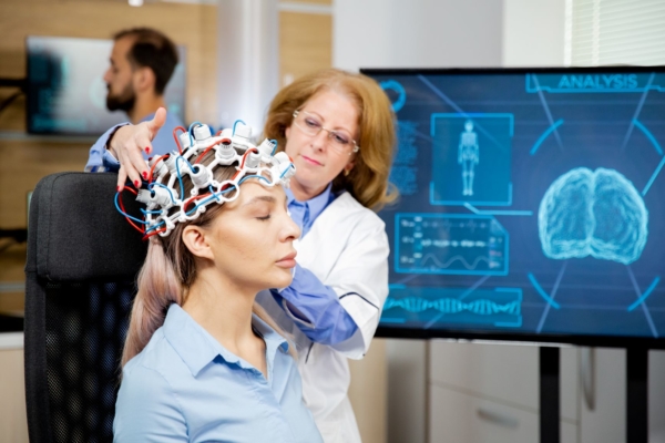 Doctor arranging neurology scanning headset