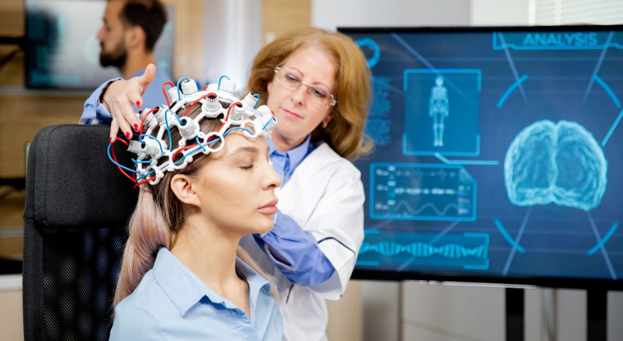 Doctor arranging neurology scanning headset